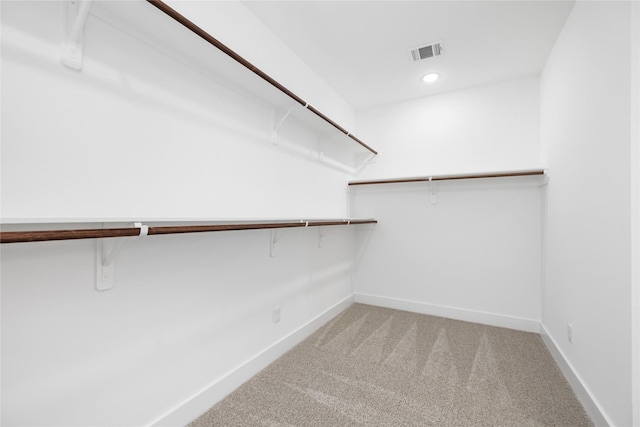 walk in closet featuring visible vents and carpet floors