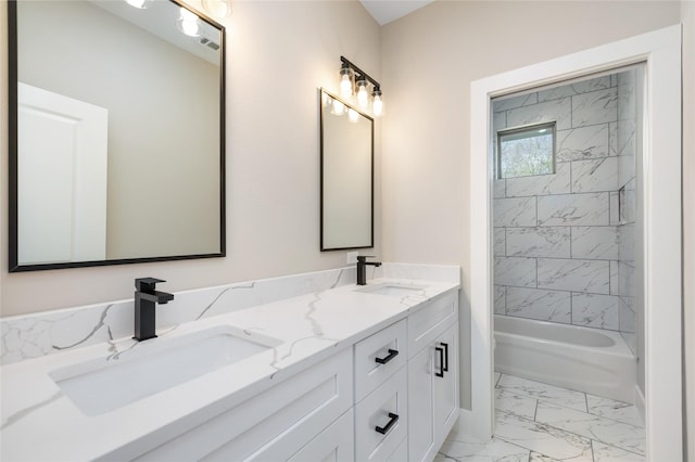 bathroom featuring a sink, visible vents, marble finish floor, and double vanity