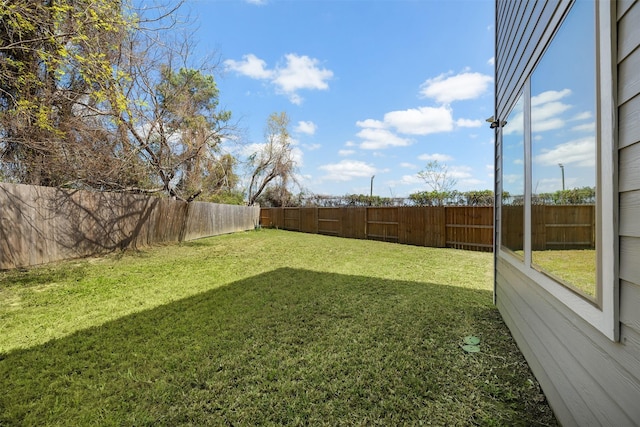 view of yard with a fenced backyard