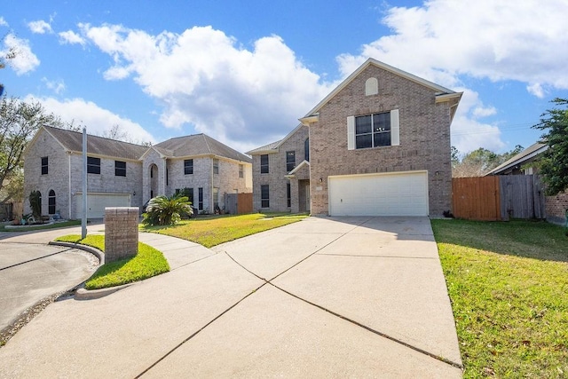 view of front of property featuring a front lawn, fence, concrete driveway, an attached garage, and brick siding