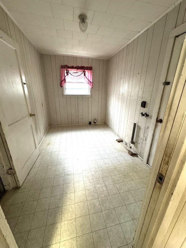 empty room with wooden walls and light floors