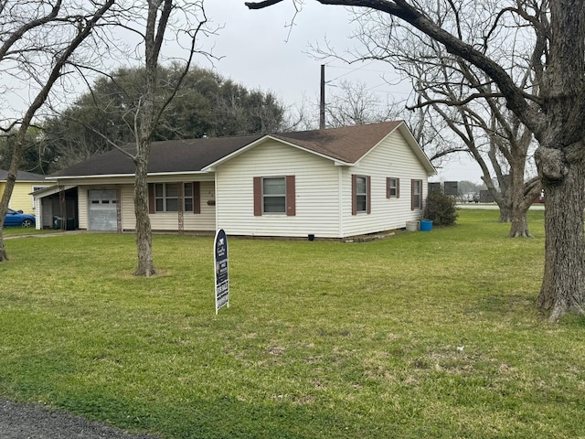 view of front of house with a front lawn, a garage, and a shingled roof