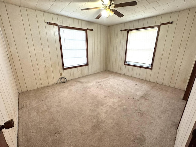 carpeted empty room featuring a ceiling fan