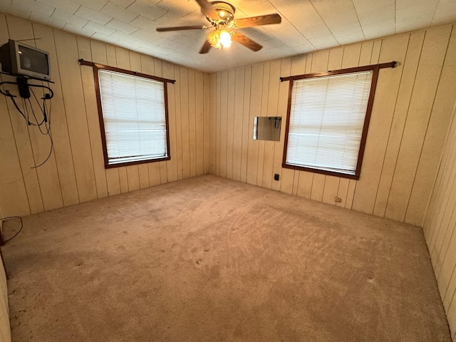 spare room featuring ceiling fan and carpet floors