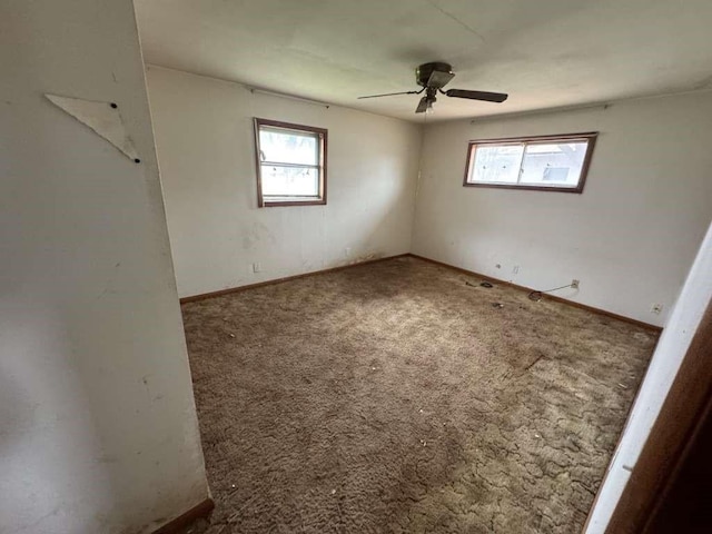 carpeted empty room with plenty of natural light and ceiling fan