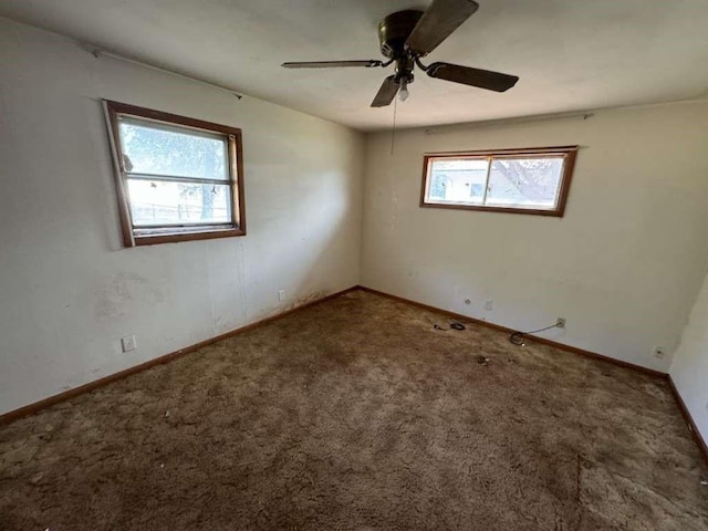 unfurnished room featuring baseboards, carpet, and ceiling fan