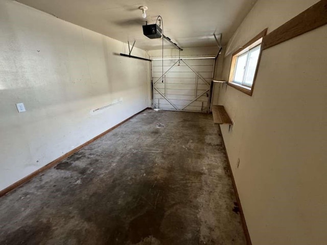 garage with a garage door opener and baseboards