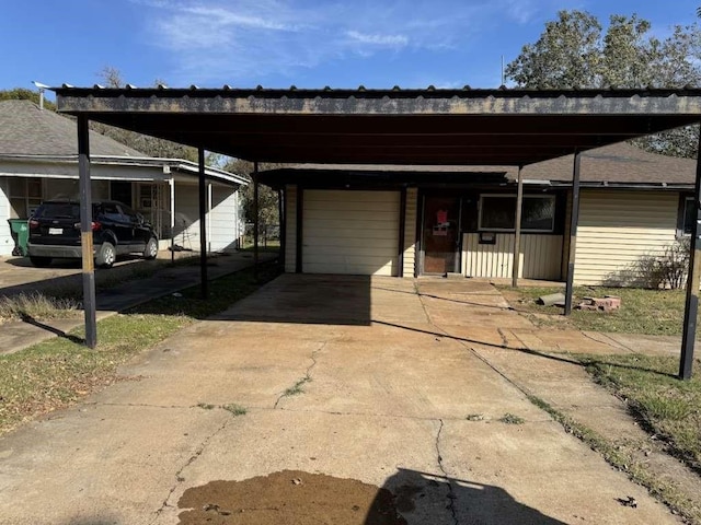 view of front facade with a carport, an attached garage, and driveway