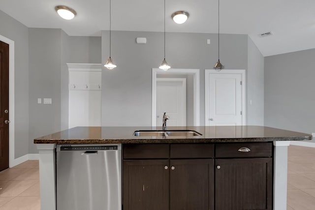 kitchen with a sink, stainless steel dishwasher, dark brown cabinetry, light tile patterned floors, and hanging light fixtures