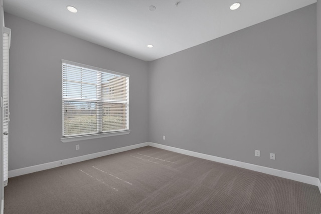 carpeted empty room with recessed lighting and baseboards