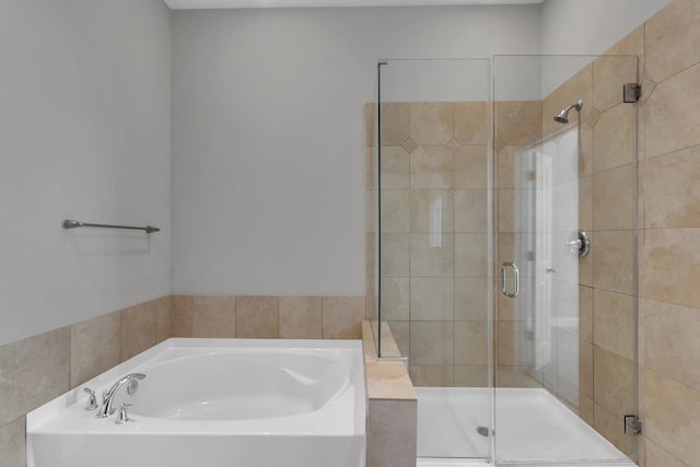 bathroom with a garden tub and a stall shower