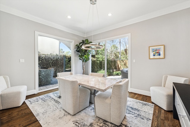 dining room featuring recessed lighting, wood finished floors, baseboards, and ornamental molding