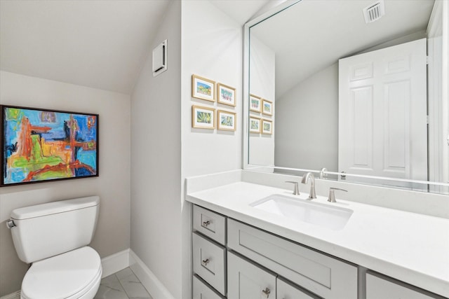 half bathroom with visible vents, toilet, marble finish floor, baseboards, and vanity