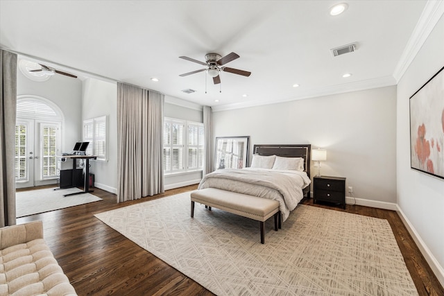 bedroom featuring visible vents, wood finished floors, crown molding, baseboards, and access to exterior