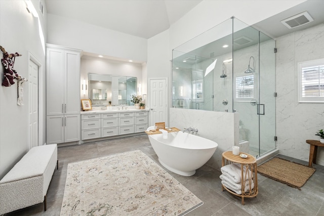 full bath with a freestanding tub, visible vents, a stall shower, and vanity