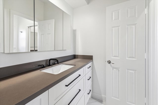 bathroom featuring vanity and baseboards