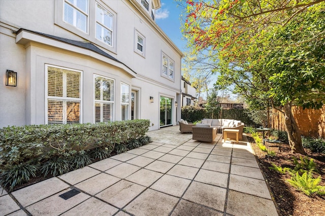 view of patio / terrace featuring an outdoor living space and fence