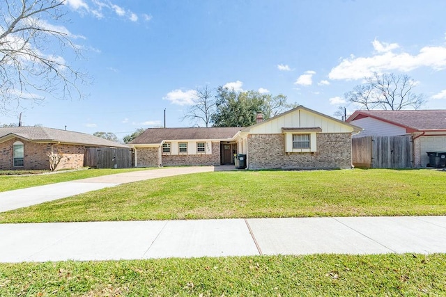 ranch-style home featuring brick siding, board and batten siding, fence, concrete driveway, and a front yard