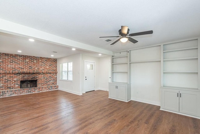 unfurnished living room with baseboards, wood finished floors, visible vents, and ceiling fan