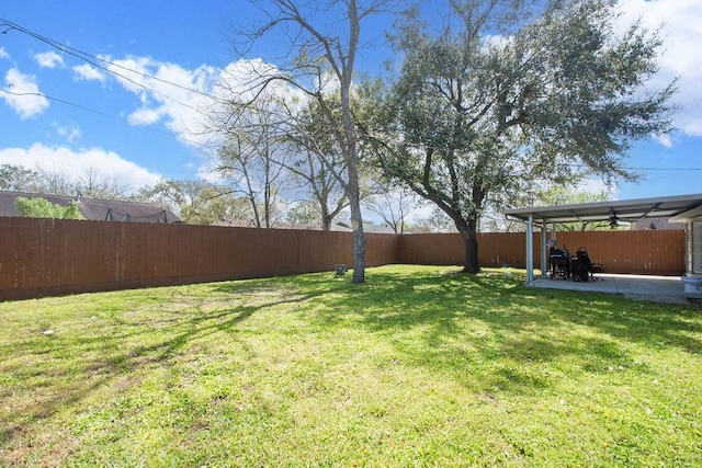 view of yard featuring a ceiling fan, a patio area, and a fenced backyard