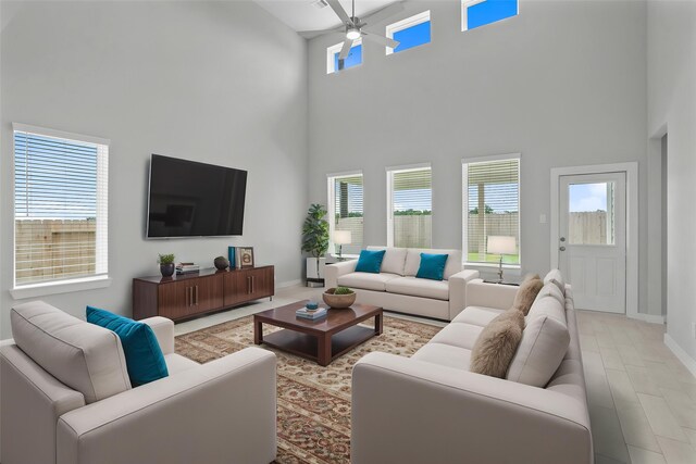 357 Spruce Oak Ln, Waller, TX 77484 - living room featuring a high ceiling, ceiling fan, plenty of natural light, and baseboards