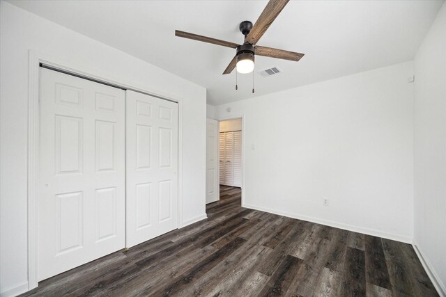 2003 Long Barrel Ln, Missouri City, TX 77489 - unfurnished bedroom with visible vents, ceiling fan, baseboards, a closet, and dark wood-style flooring