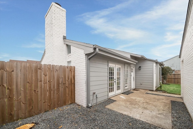 2003 Long Barrel Ln, Missouri City, TX 77489 - back of house with a patio, fence, french doors, brick siding, and a chimney