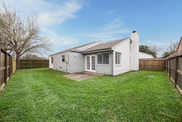 2003 Long Barrel Ln, Missouri City, TX 77489 - rear view of property with french doors, a lawn, a fenced backyard, and a chimney