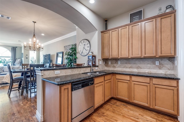 kitchen featuring visible vents, a sink, stainless steel dishwasher, a peninsula, and a chandelier