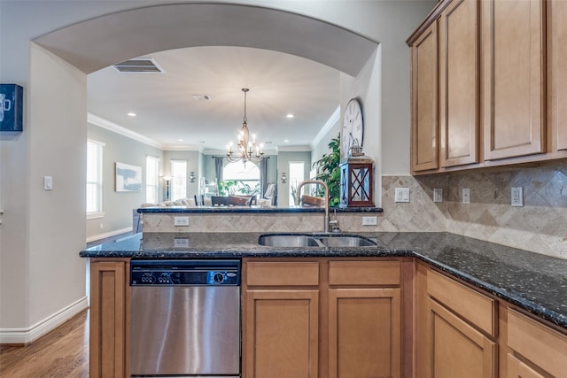 kitchen featuring visible vents, open floor plan, dishwasher, a peninsula, and a sink