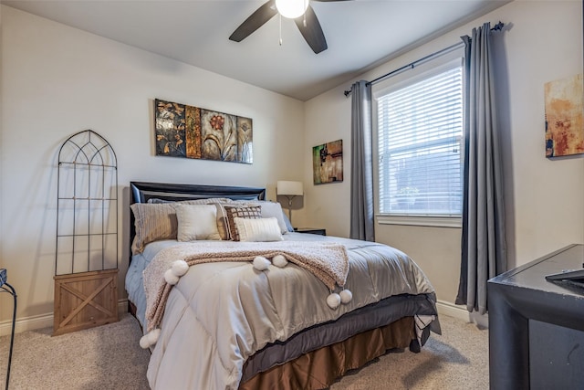 carpeted bedroom with baseboards and ceiling fan