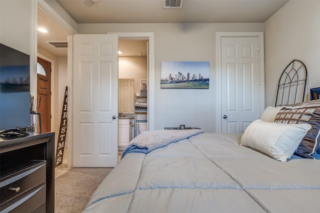 carpeted bedroom featuring visible vents