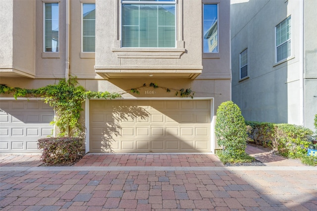 garage featuring decorative driveway