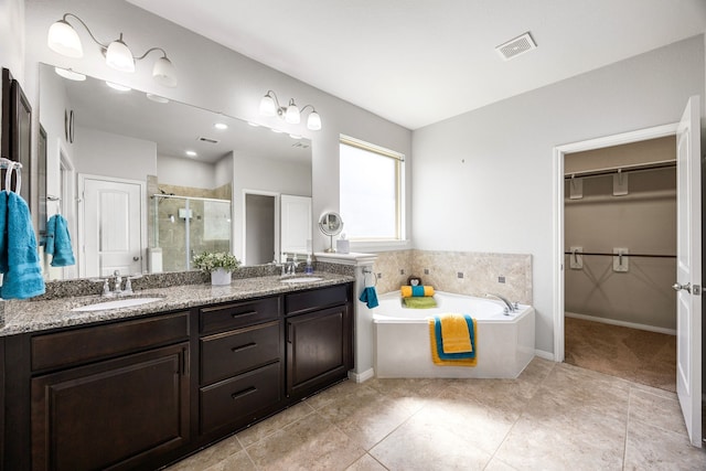 full bathroom featuring a sink, visible vents, double vanity, and a shower stall