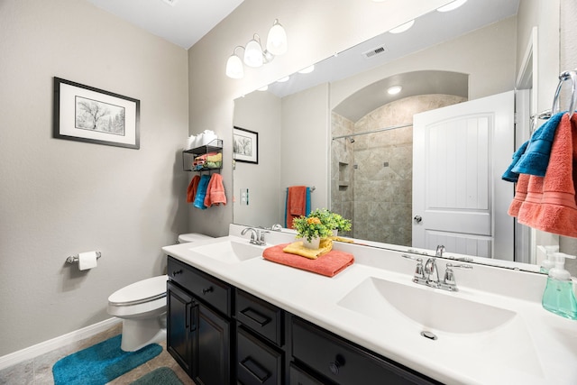 full bathroom with visible vents, tiled shower, toilet, and a sink