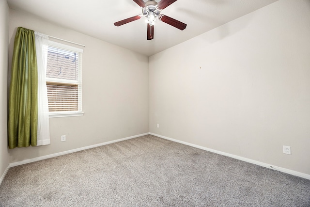 empty room with baseboards, carpet floors, and a ceiling fan