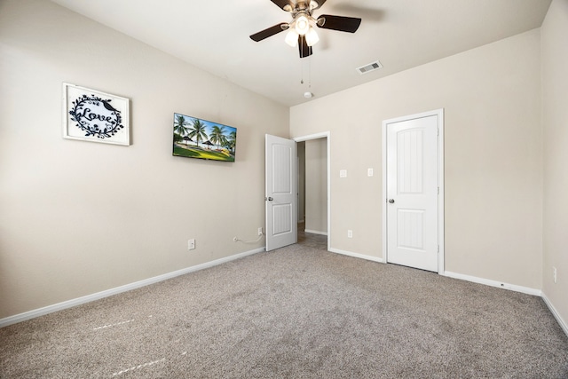 unfurnished bedroom featuring visible vents, baseboards, a ceiling fan, and carpet flooring