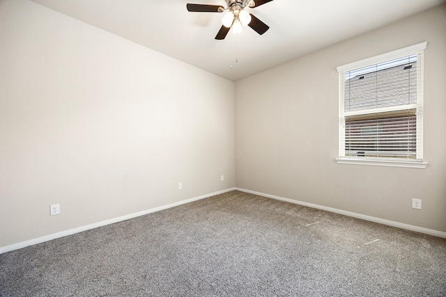 spare room with baseboards, ceiling fan, and carpet floors