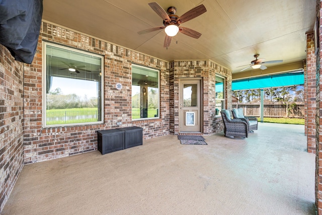 view of patio featuring a ceiling fan and fence