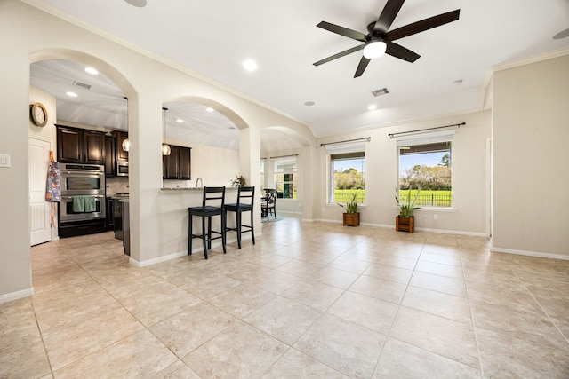 kitchen featuring a breakfast bar area, a ceiling fan, visible vents, appliances with stainless steel finishes, and open floor plan