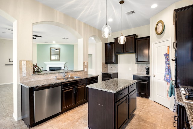 kitchen with visible vents, a sink, stainless steel dishwasher, tasteful backsplash, and arched walkways