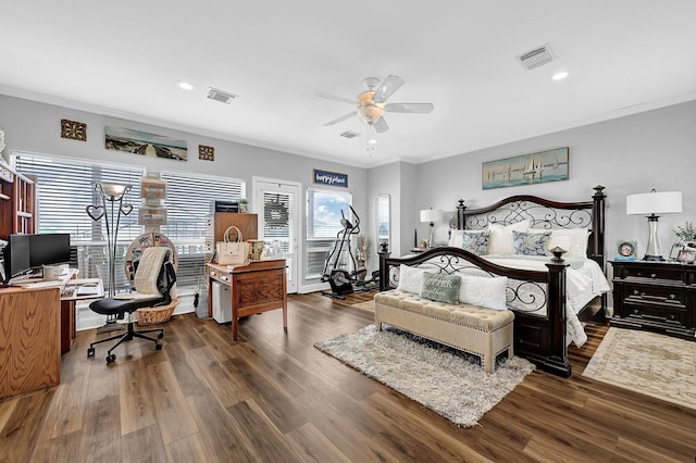 bedroom with wood finished floors, visible vents, and ornamental molding