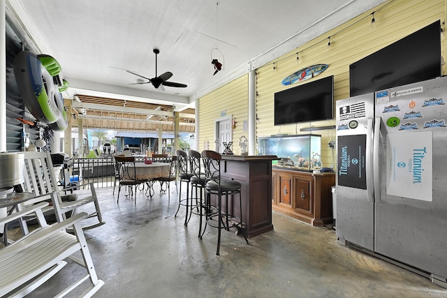 exterior space with outdoor dry bar and a ceiling fan