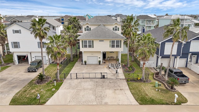 view of front of house featuring a residential view, concrete driveway, a garage, and a gate