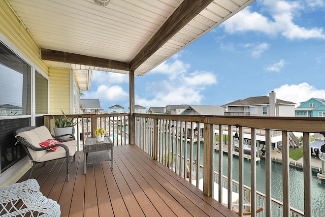 wooden deck with a water view and a residential view