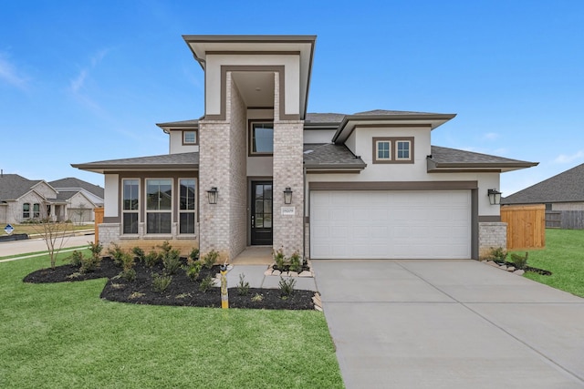 prairie-style home with fence, driveway, roof with shingles, a front lawn, and brick siding