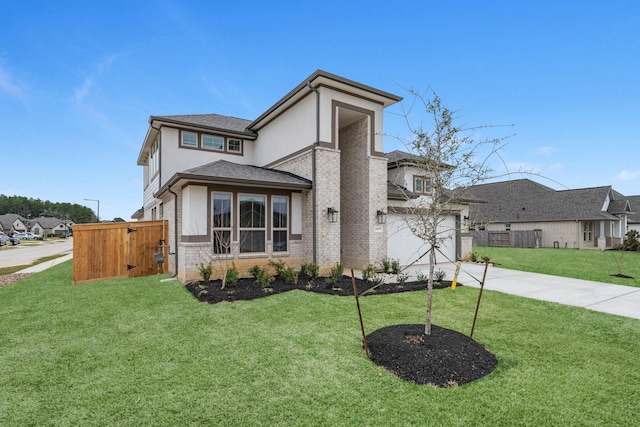 prairie-style house featuring brick siding, a front lawn, fence, stucco siding, and driveway