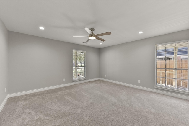 carpeted spare room featuring recessed lighting, baseboards, and a ceiling fan