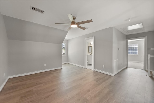 bonus room with a ceiling fan, visible vents, attic access, vaulted ceiling, and light wood-style floors