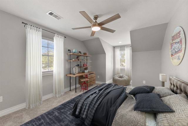 carpeted bedroom with a ceiling fan, lofted ceiling, baseboards, and visible vents